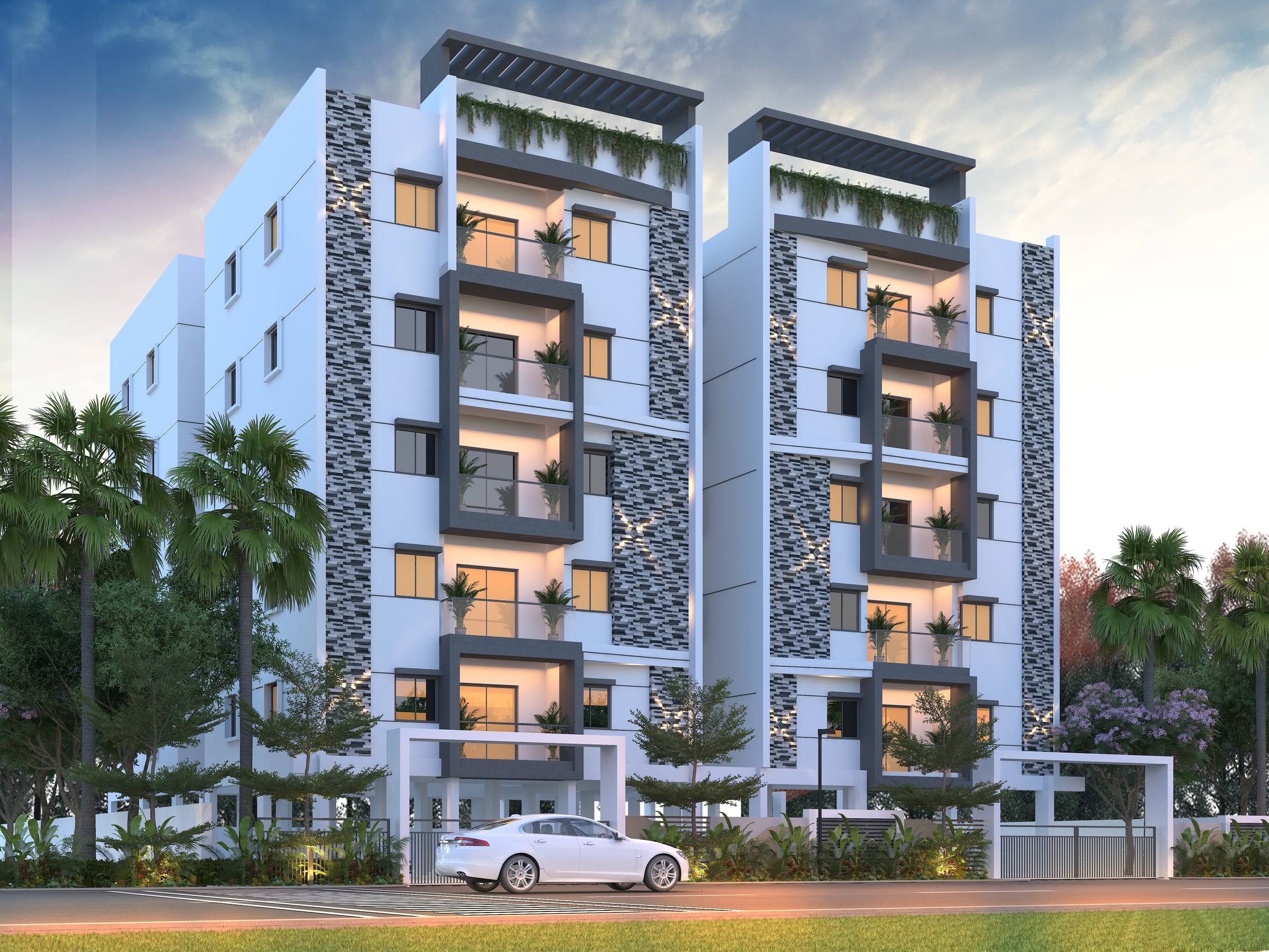 Corner view of a King's Court 3 BHK block at dusk, showing balconies and stone cladding